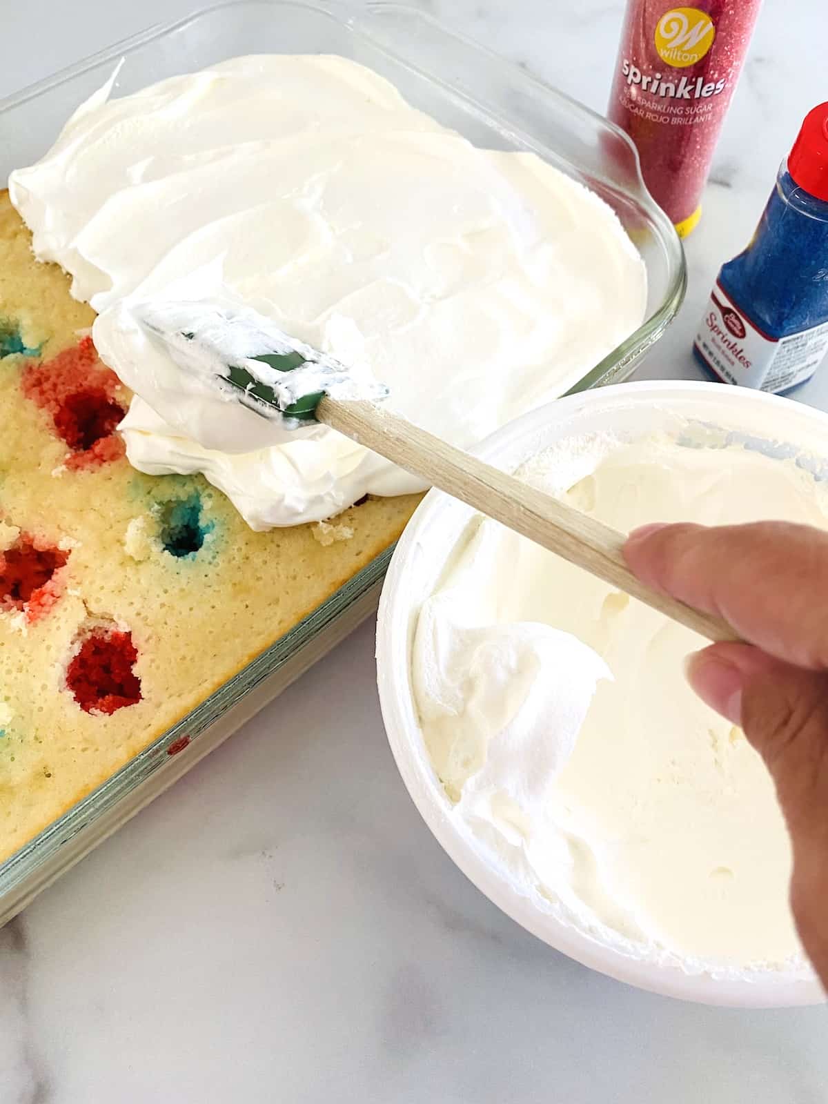 Patriotic Red, White, & Blue Poke Cake Frosting with the CoolWhip.