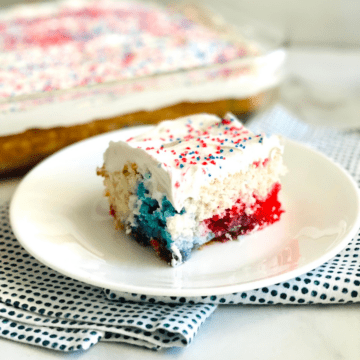 Patriotic Red, White, & Blue Poke Cake plated ready to eat.