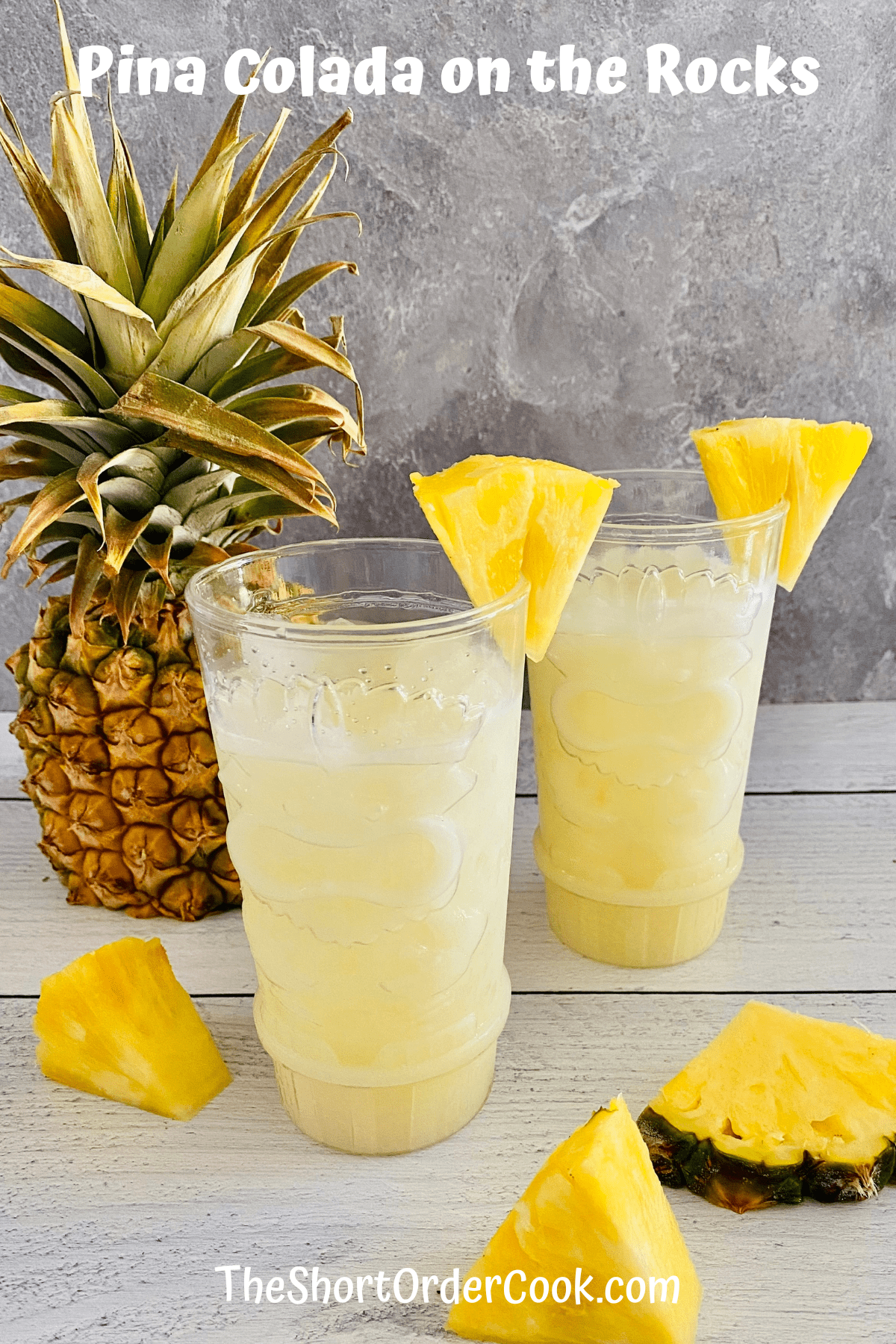 Two glasses filled with pina colada on the rocks ready to drink.