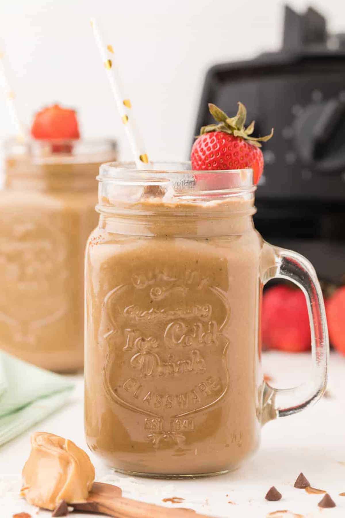Two mugs of chocolate smoothies.