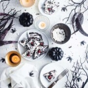 White chocolate candy bark with cookie and frosting black spiders.