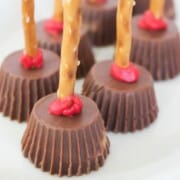 Peanut butter cups with pretzel sticks to look like witches brooms.