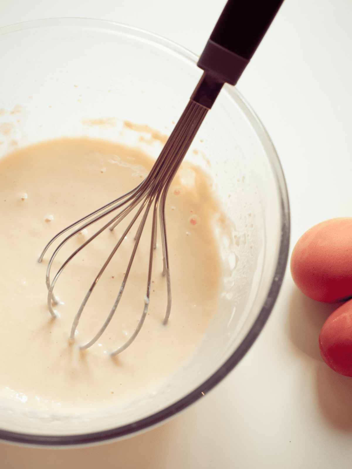 Mixing dairy-free pancake batter in a large mixing bowl.