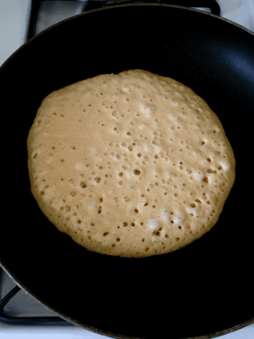 Bubbles popping on pancakes that are ready to flip.
