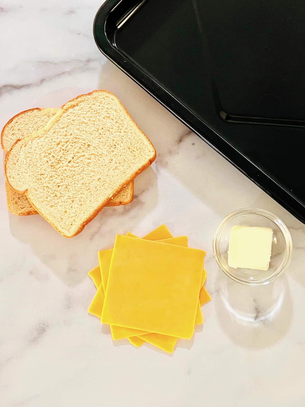 https://theshortordercook.com/wp-content/uploads/2022/08/Toaster-Oven-Grilled-Cheese-Sandwich-Ingredients-on-a-table.jpg