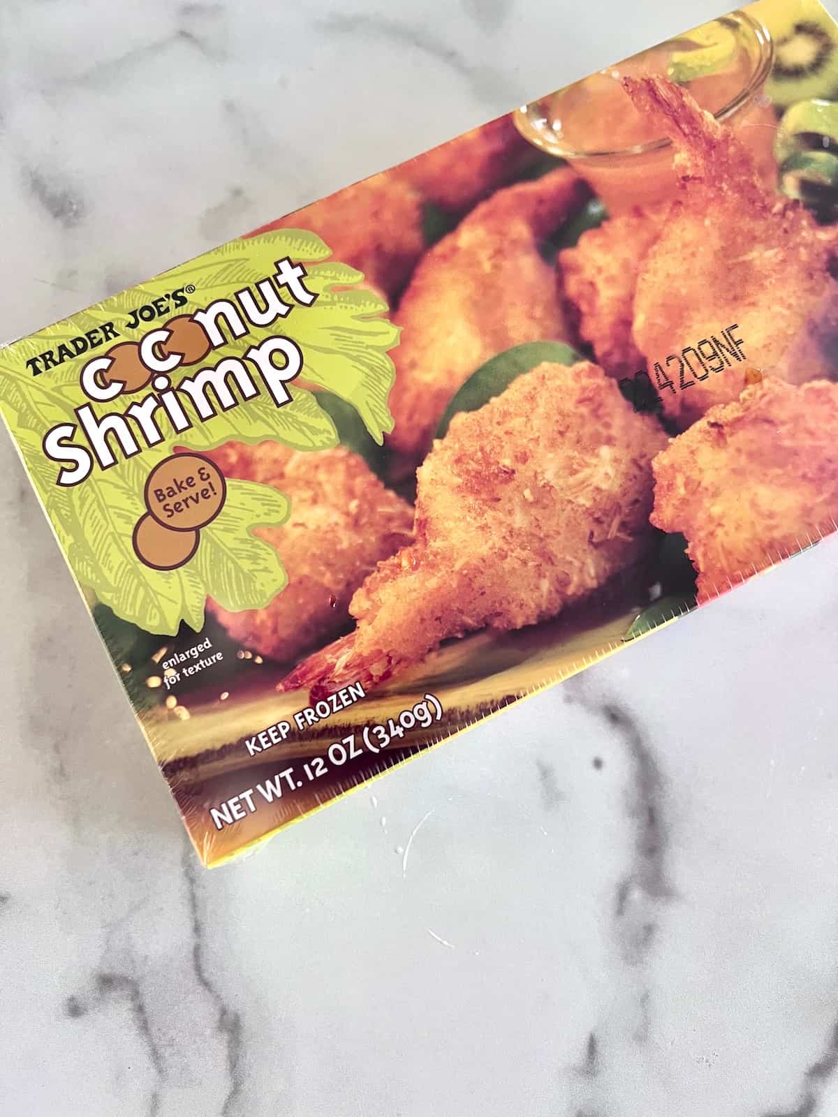 Air Fryer Frozen Coconut Shrimp Box of Trader Joes Coconut Shrimp still frozen on a table.