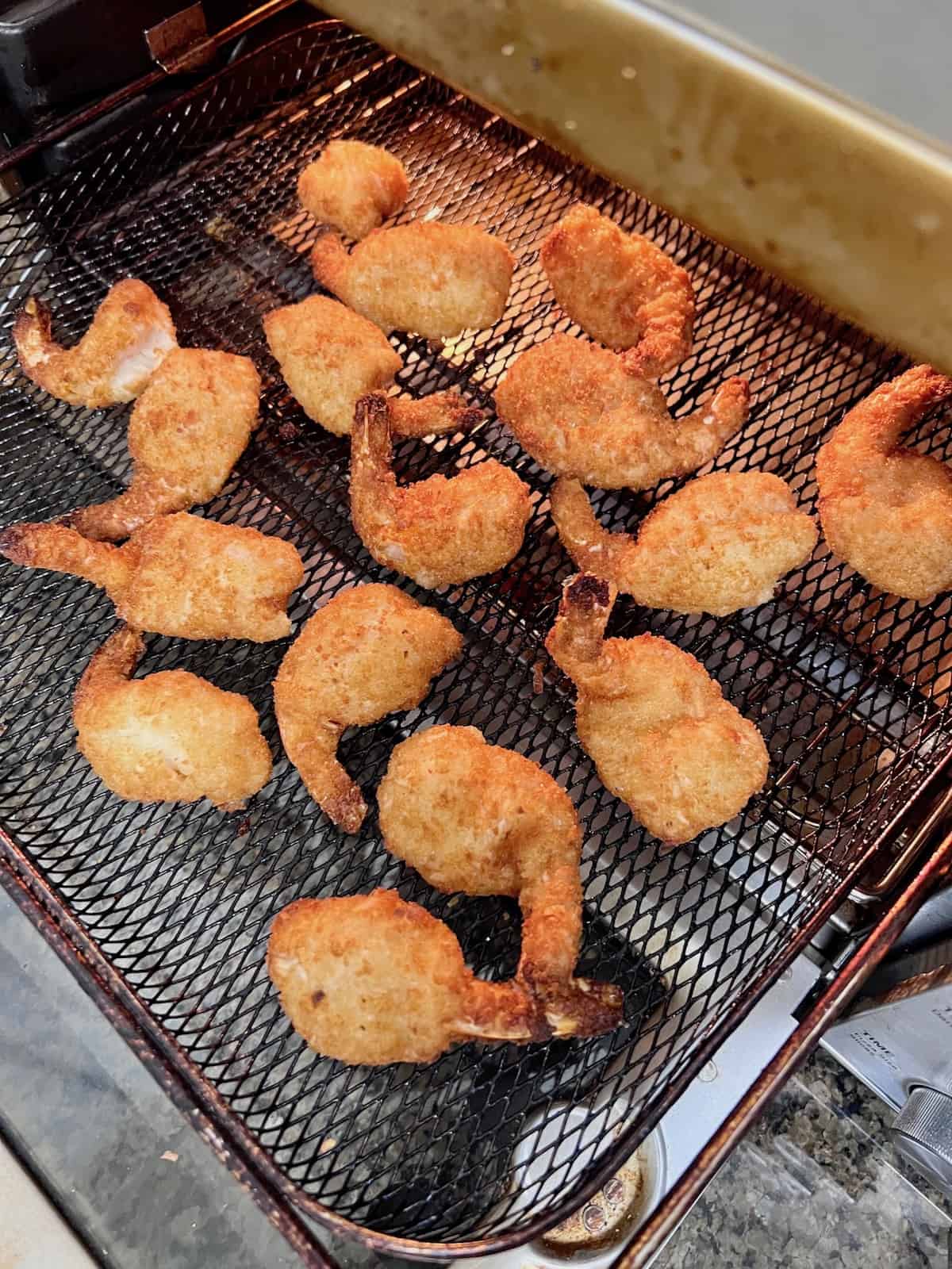 Air Fryer Frozen Coconut Shrimp Hot and crispy on the air fryer tray.