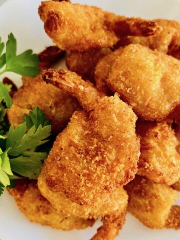 Overhead image of a plate of cooked coconut shrimp.