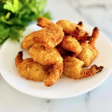 Plated frozen coconut shrimp that has been air fried.