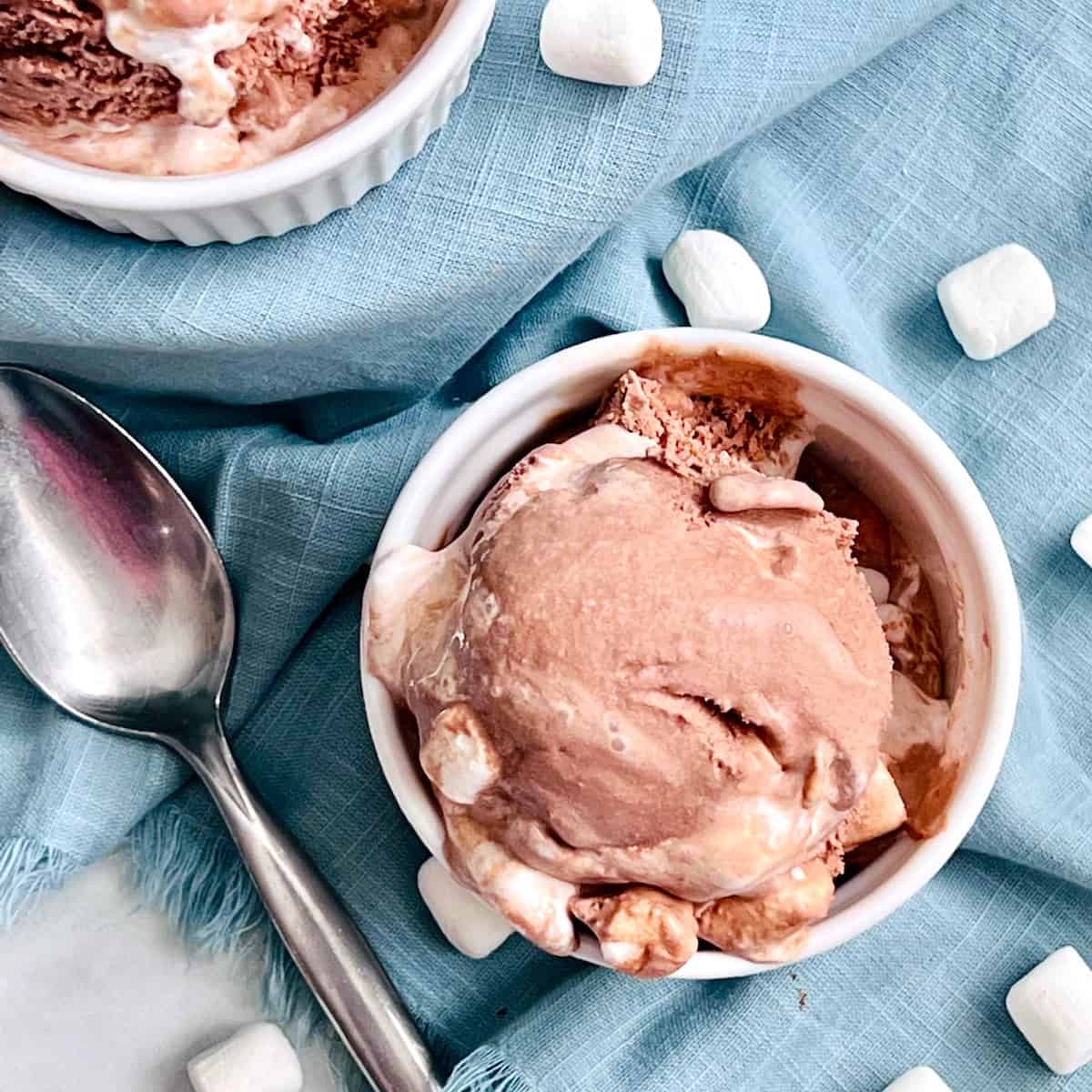 Chocolate ice cream with mini marshmallows in small white ramekins.