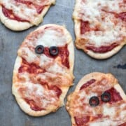 Round pizzas with oive eyes and striped cheese to look like mummies.