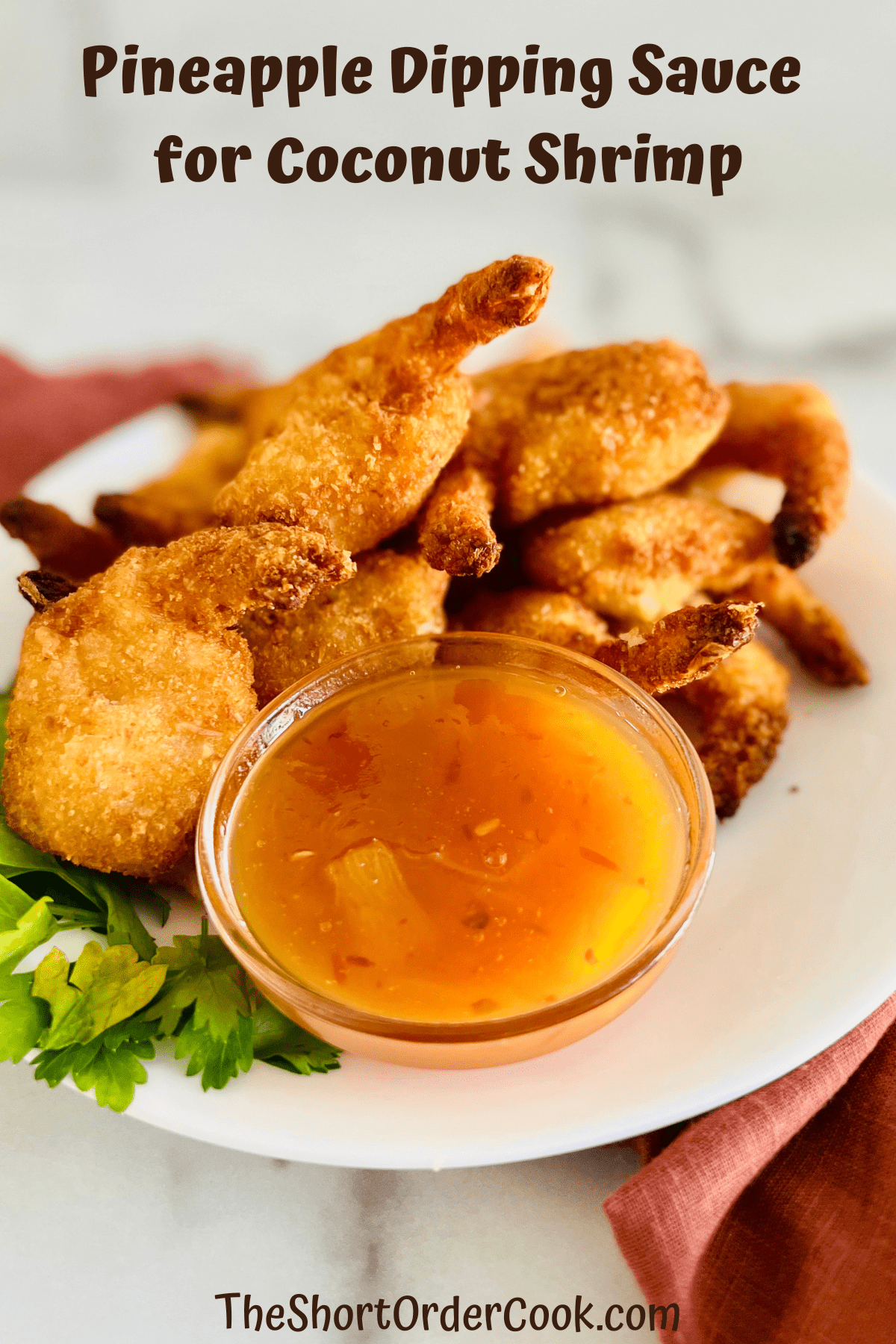 A plate of coconut shrimp with pineapple dipping sauce.