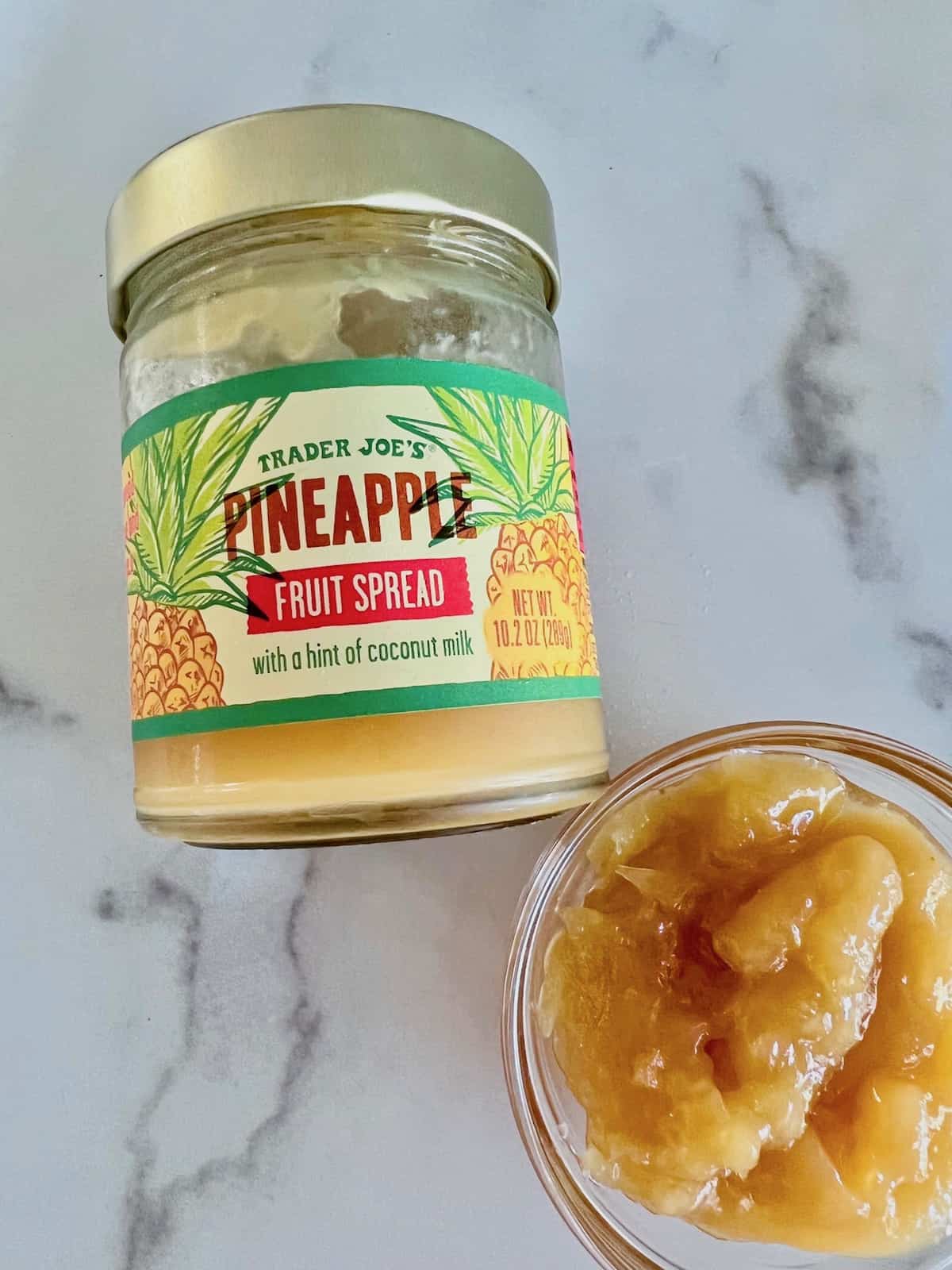 Trader Joes Pineapple fruit spread jar and some in a bowl.