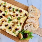 Butter board with toppings and bread for spreading.