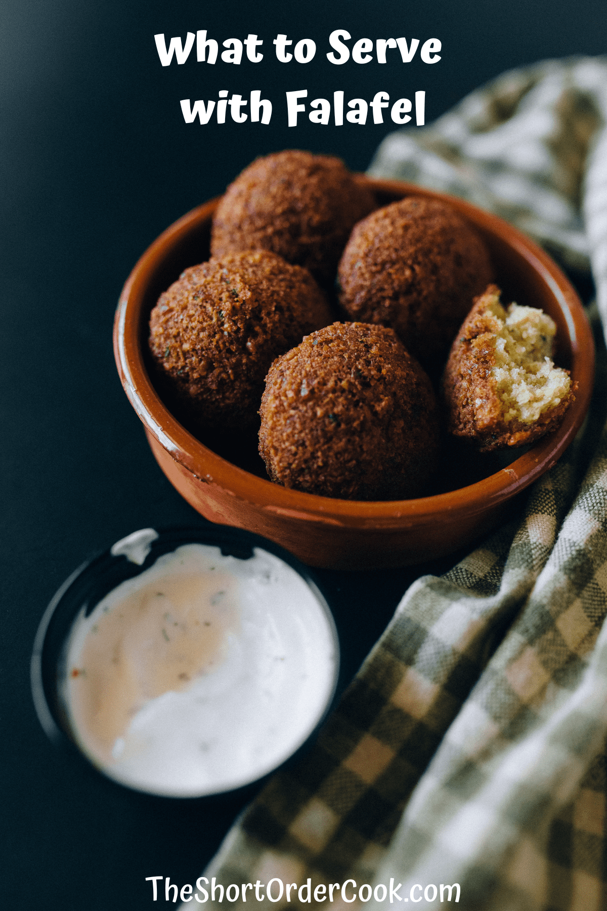 Falafels in a bowl ready to eat with dipping sauce next to it.