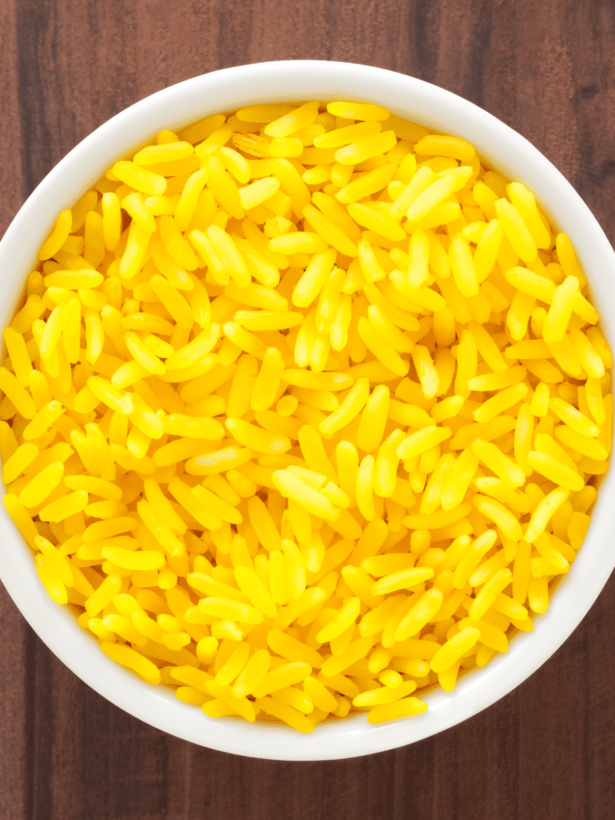Bright yellow saffron rice in a bowl.