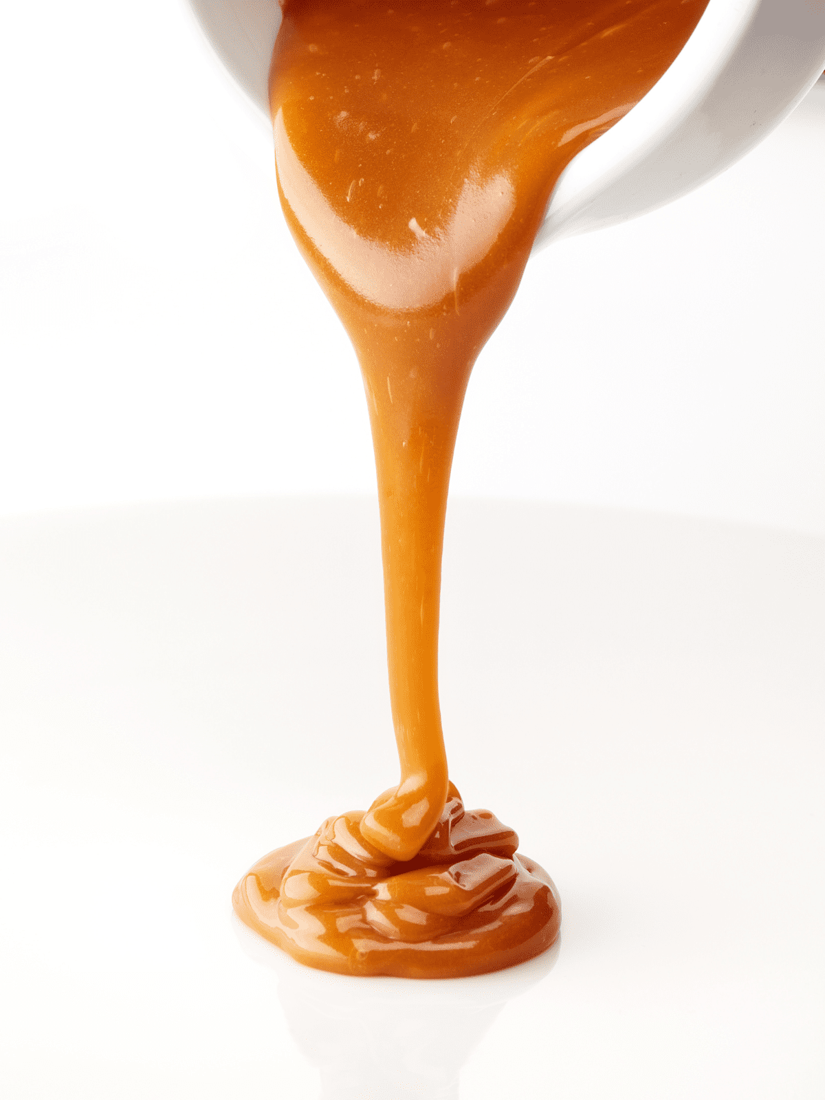 Caramel being poured on a table.