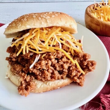 A bun topped with 3-ingredient sloppy joe meat and cheese.