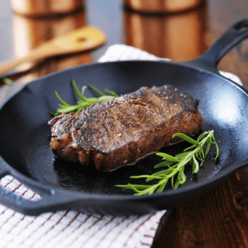 A steak seared in a pan.