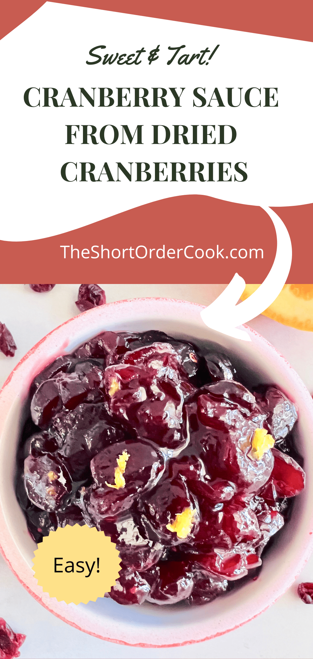 Cranberry sauce topped with orange zest in a red ramekin.