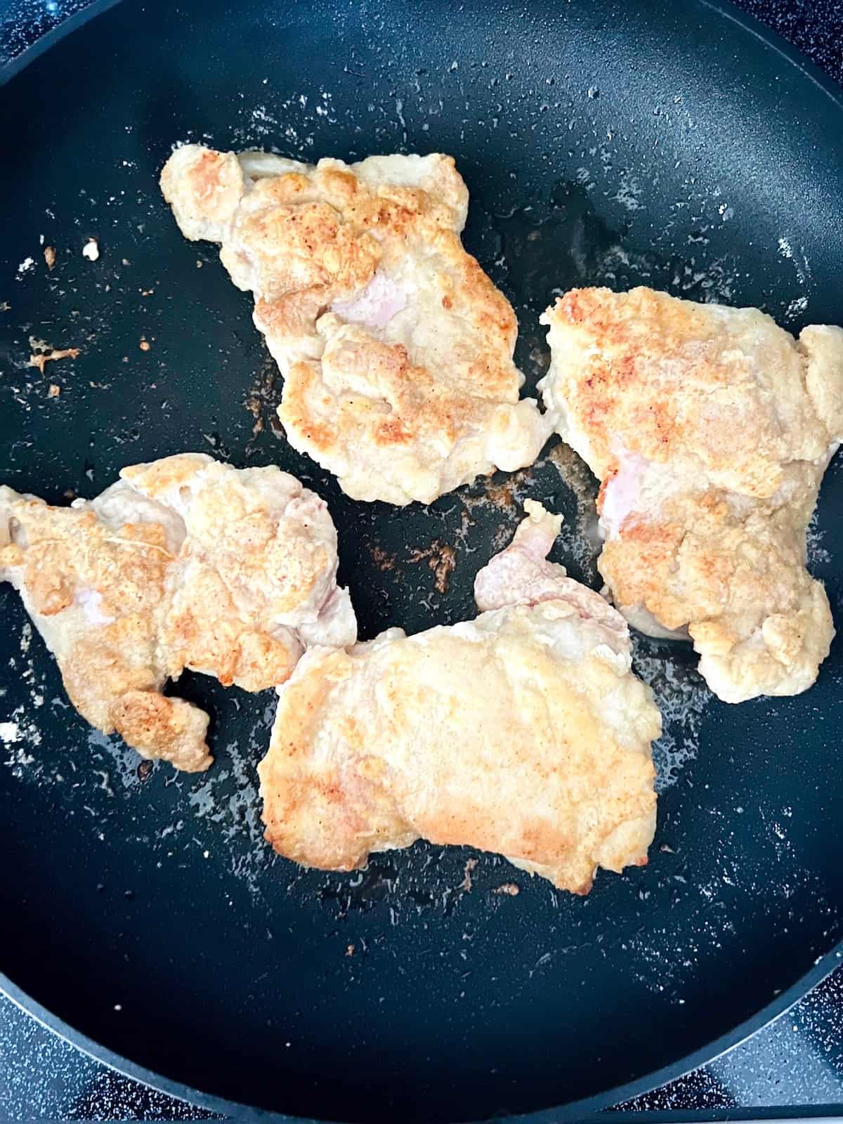 ChickenÂ Thighs browned in the skillet.