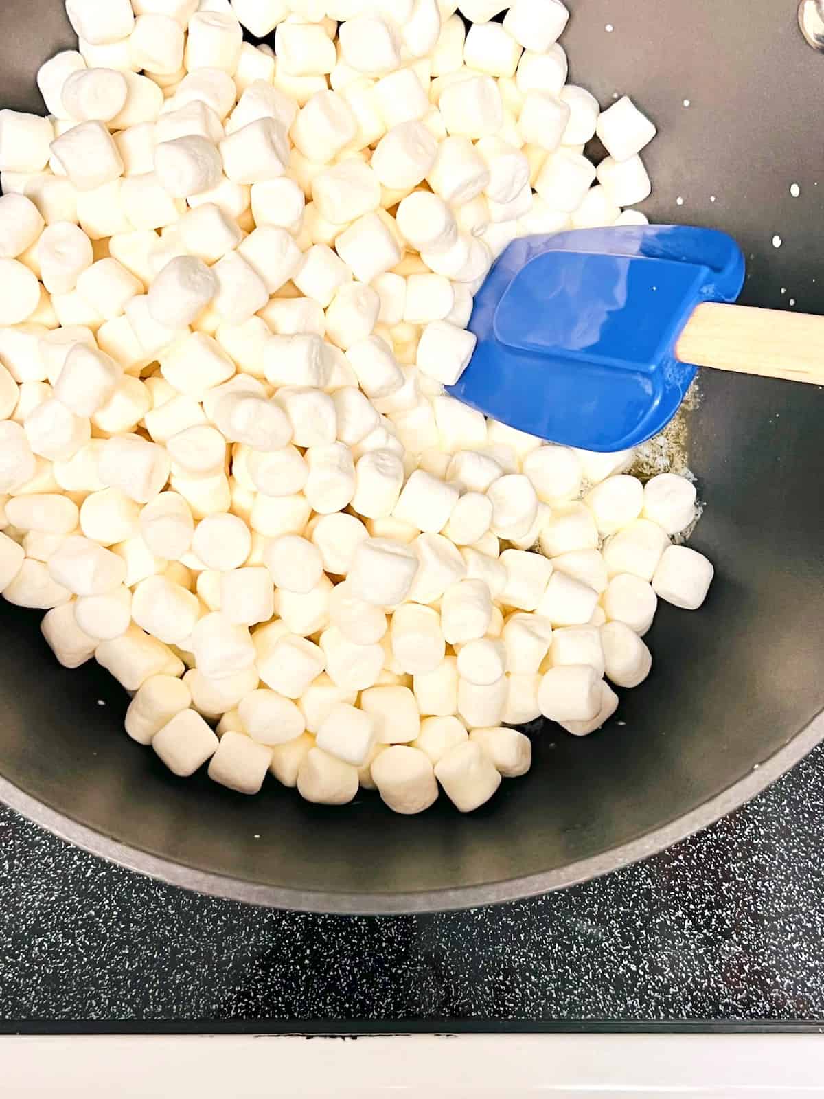 Melt the butter and mini marshmallows in a pot on the stove.