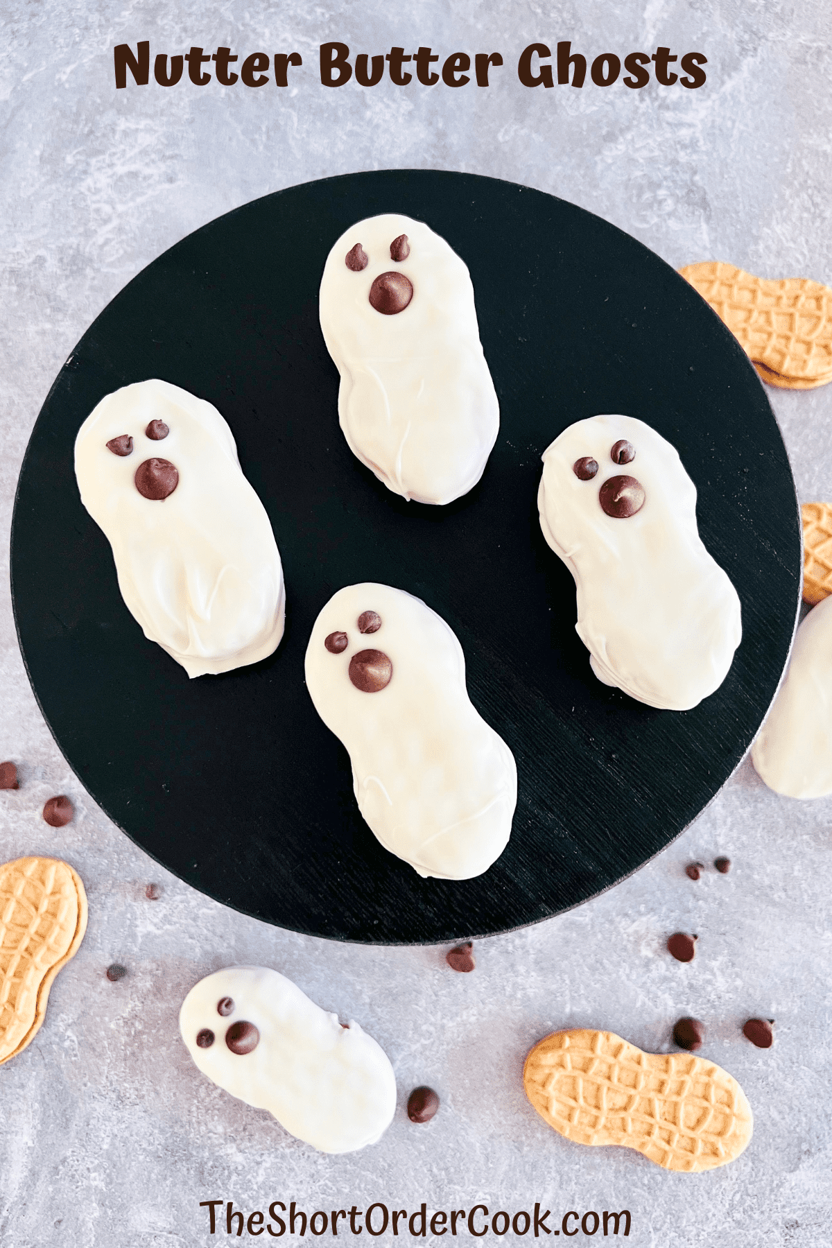 Nutter Butter Ghosts on a black round wooden board.