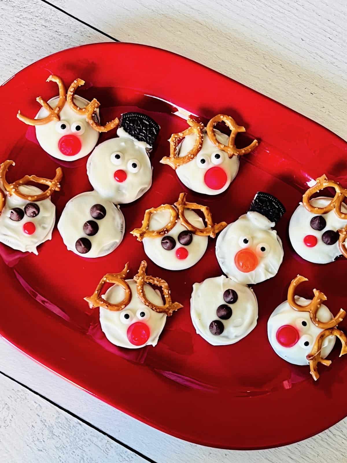 Oreo snowman & Rudolphy red-nosed reindeer cookies on a platter.