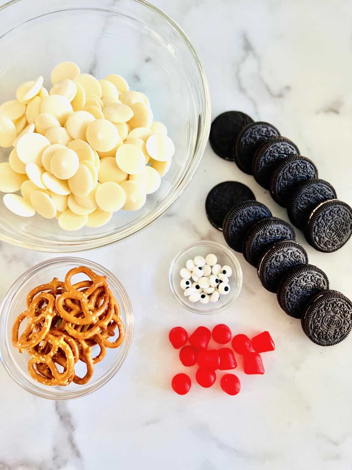 Ingredients on a table to make dipped oreo snowmen.