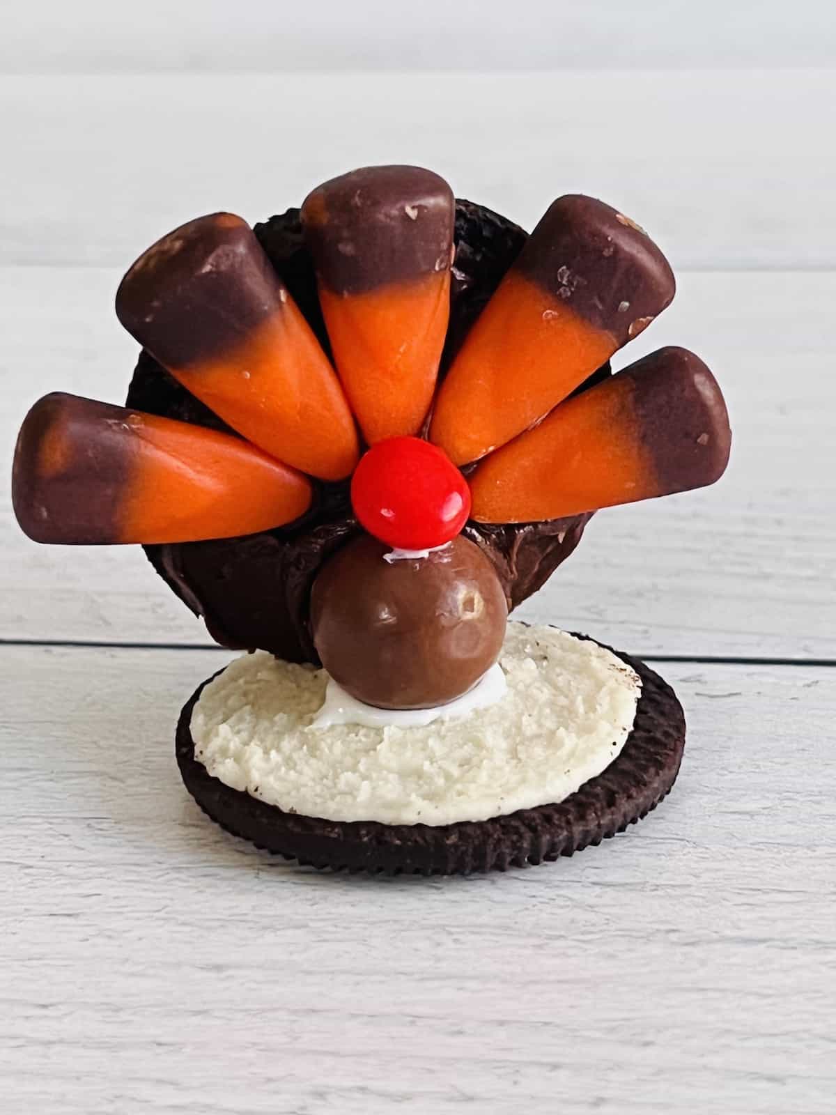 A turkey shaped cookie made from Oreo sandwiches candy corn and other candies. 
