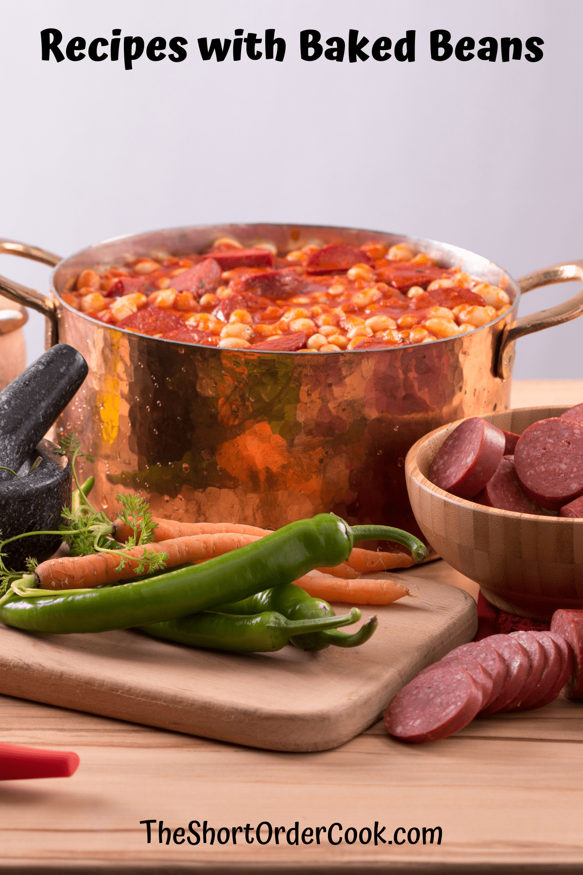 A pot of baked beans surrounded by other ingredients.