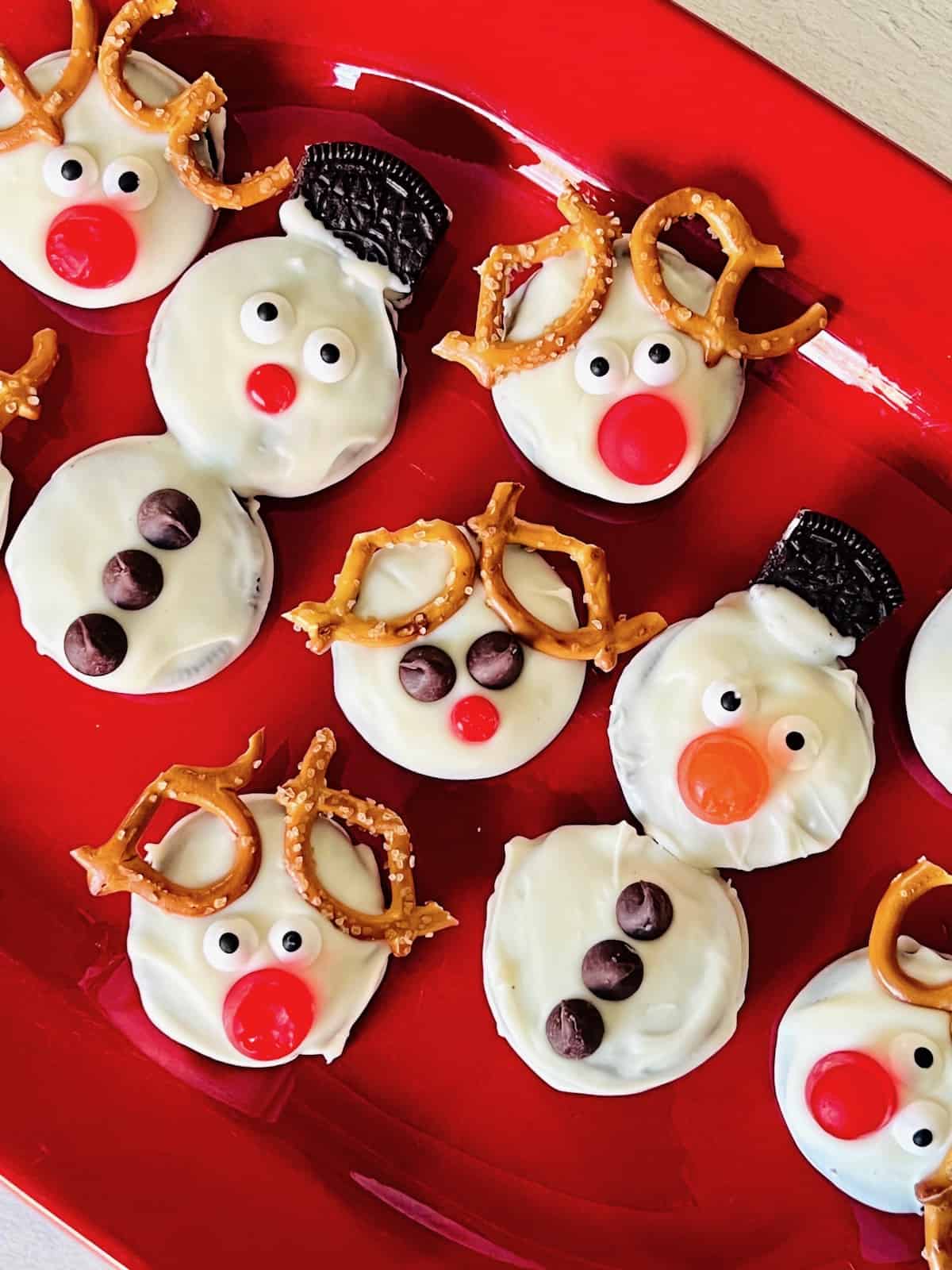 Rudolph the Red-Nosed Reindeer Cookies and Snowman cookies on a platter.