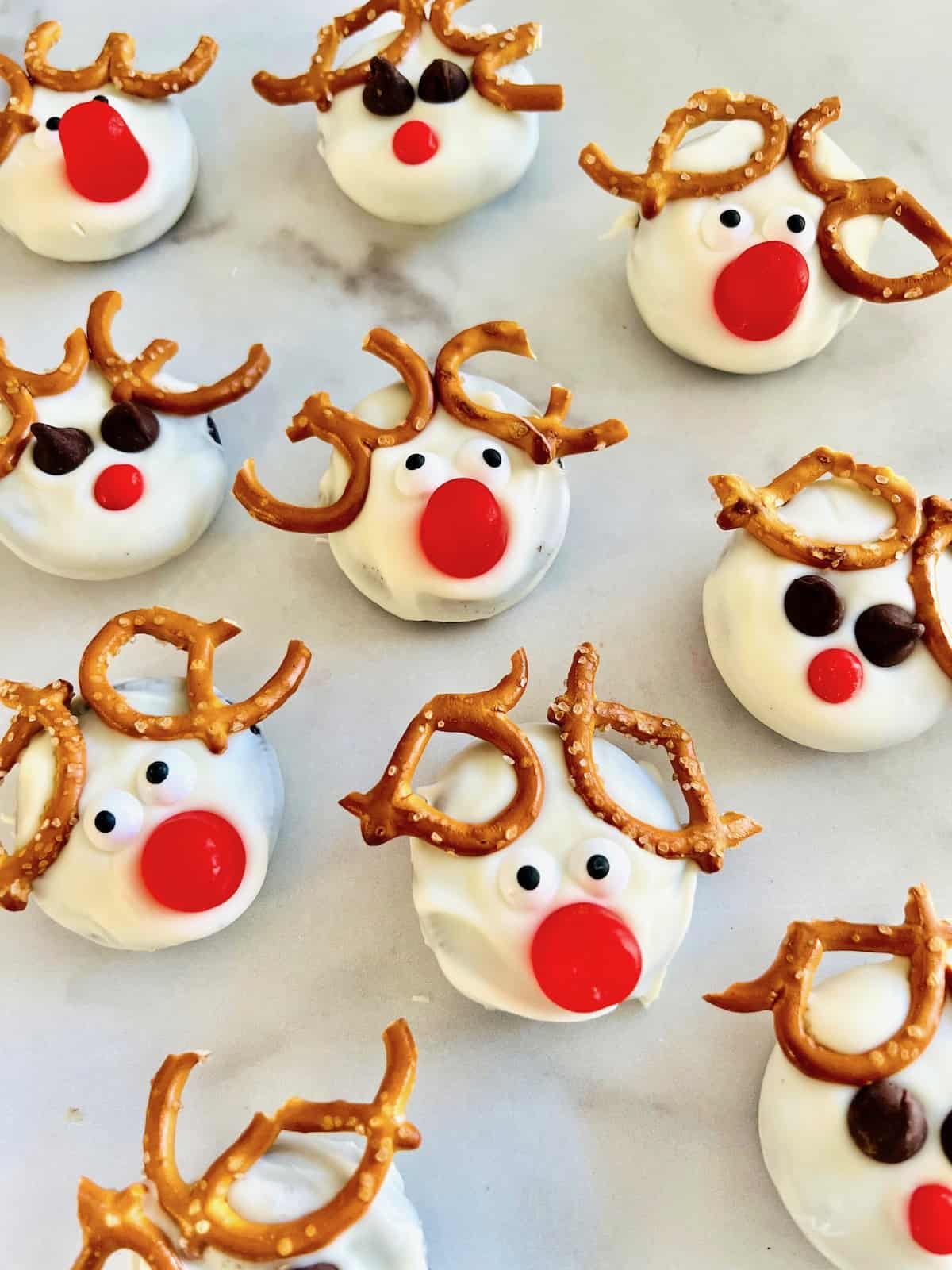 Rudolph the Red-Nosed Reindeer Cookies on a white table setting up and cooling.
