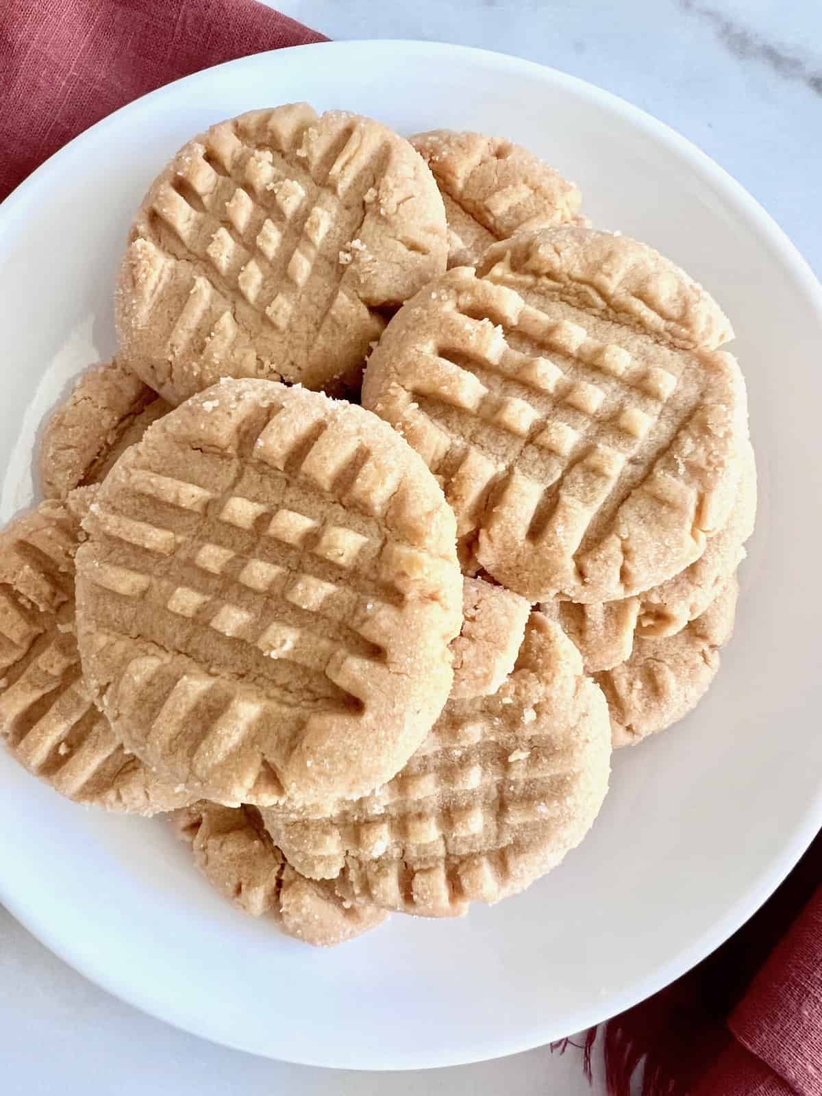 Small-Batch Peanut Butter Cookies Overhead plate closeup with red napkin.