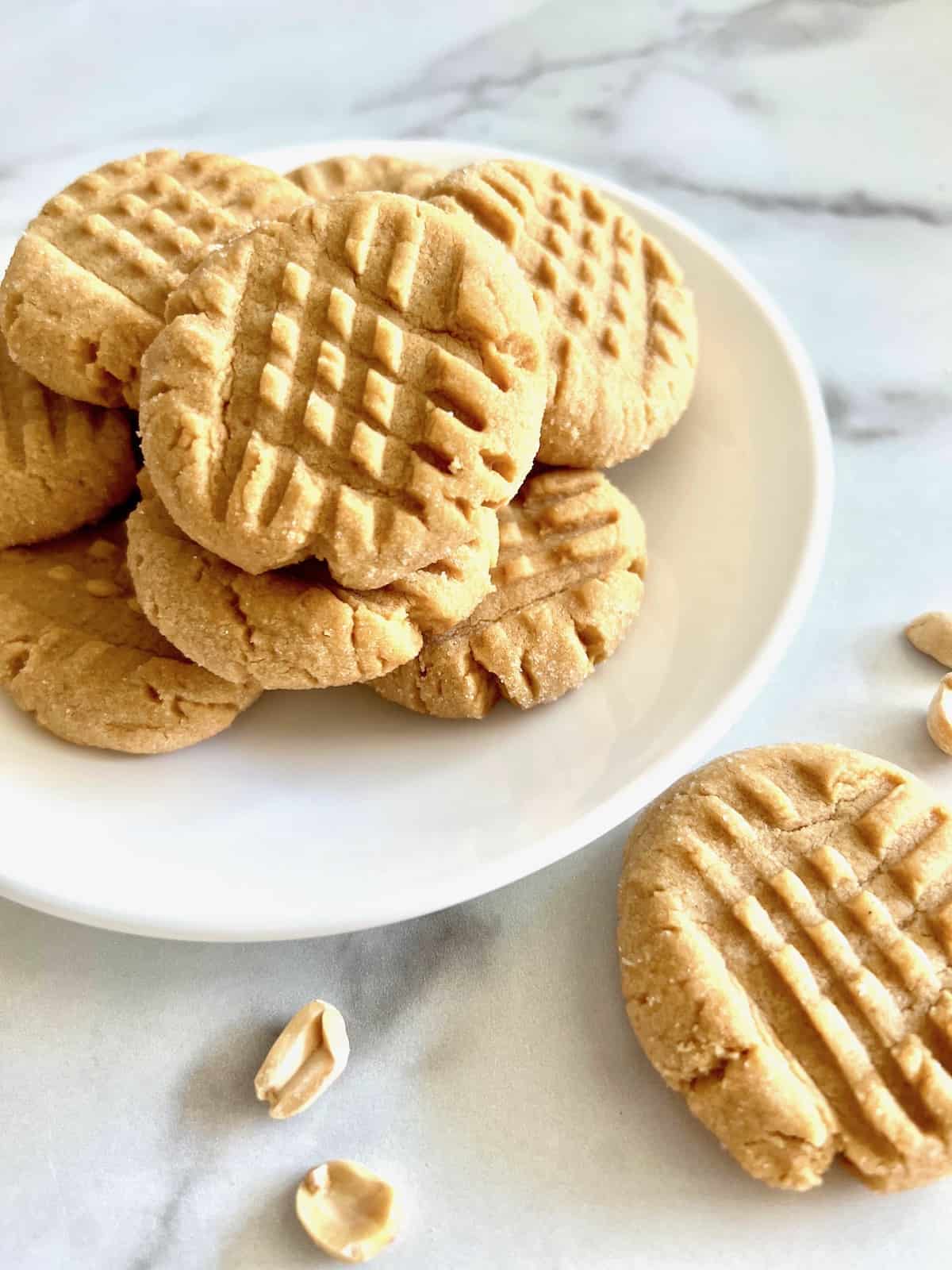 Small-Batch Peanut Butter Cookies Plated with cookie and peanuts on the table