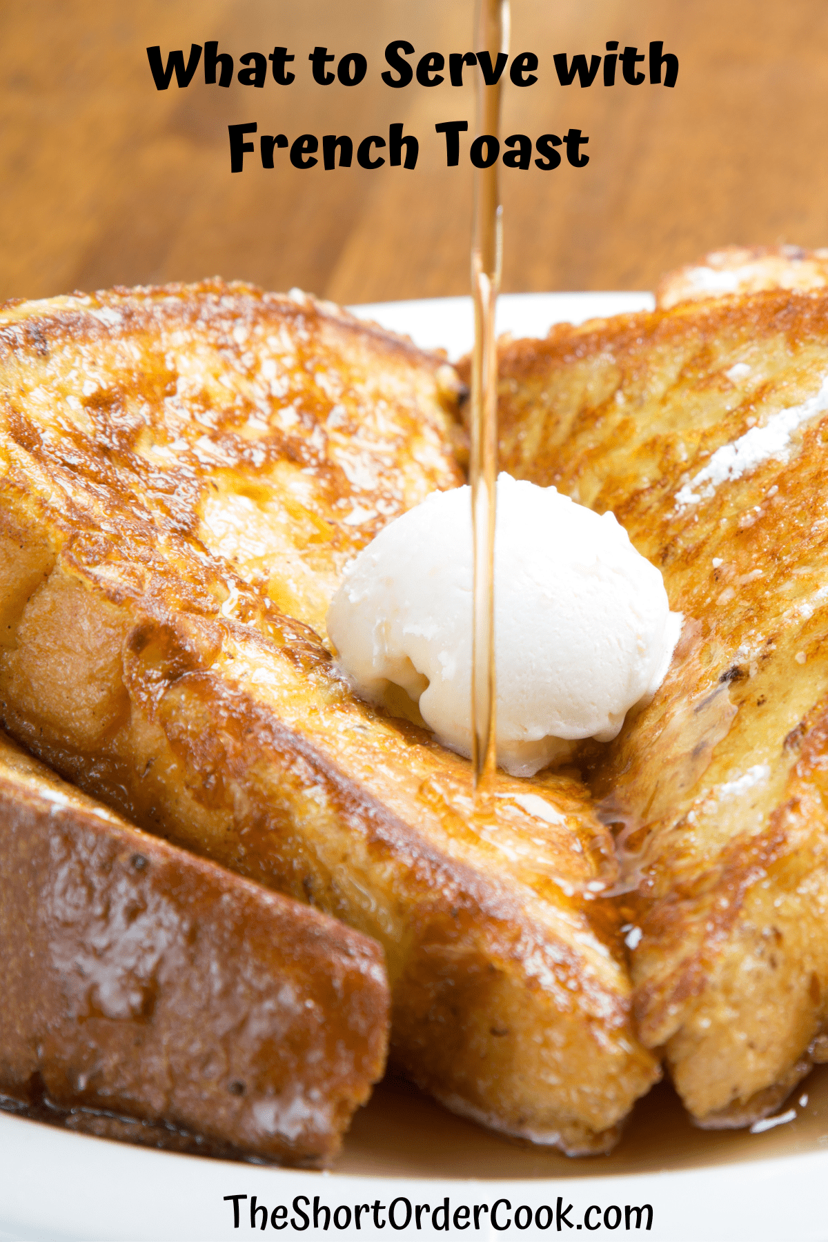 French toast with butter and syrup plated.
