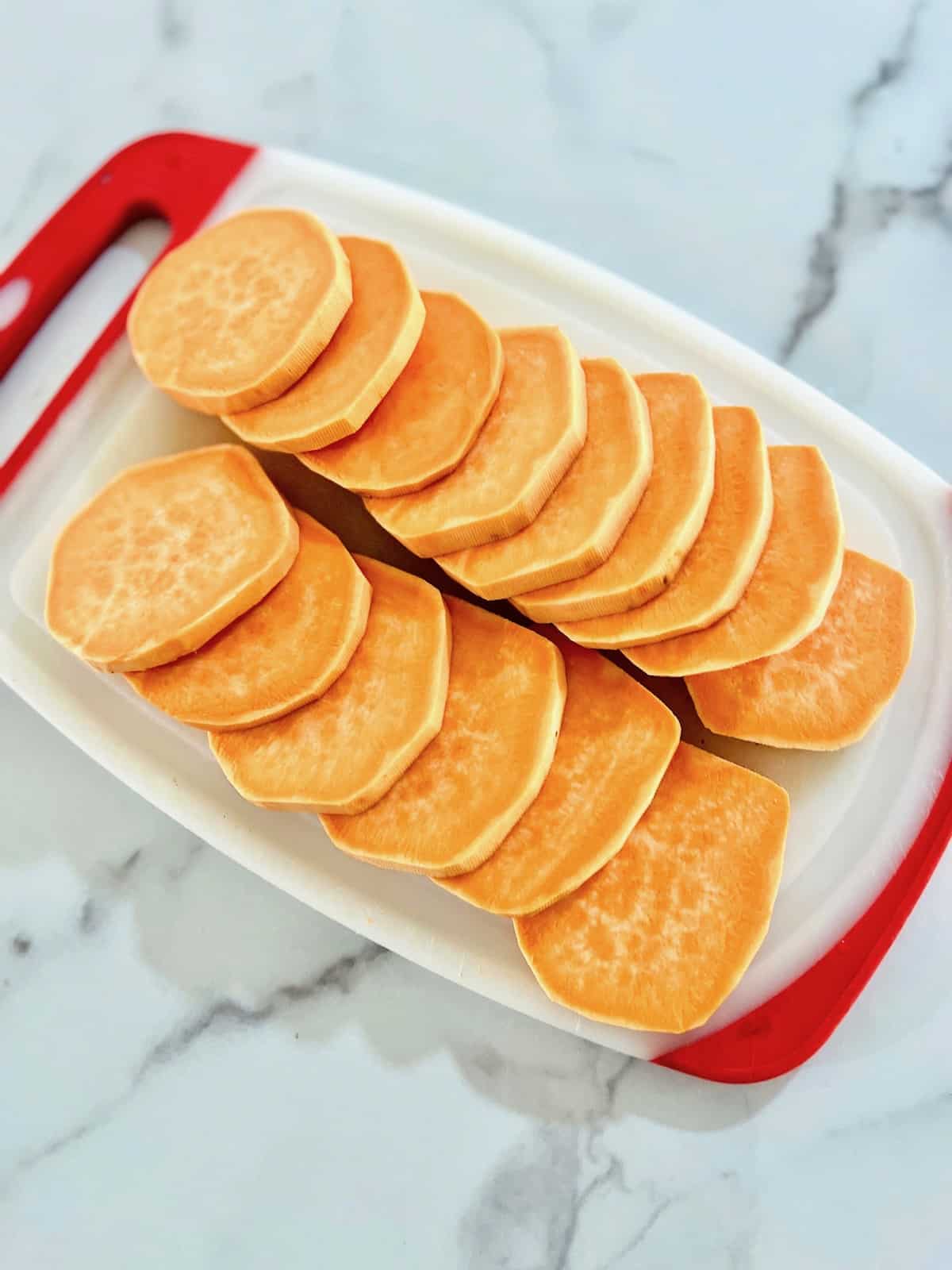Air Fryer Sweet Potato Slices Sliced on a cutting board.