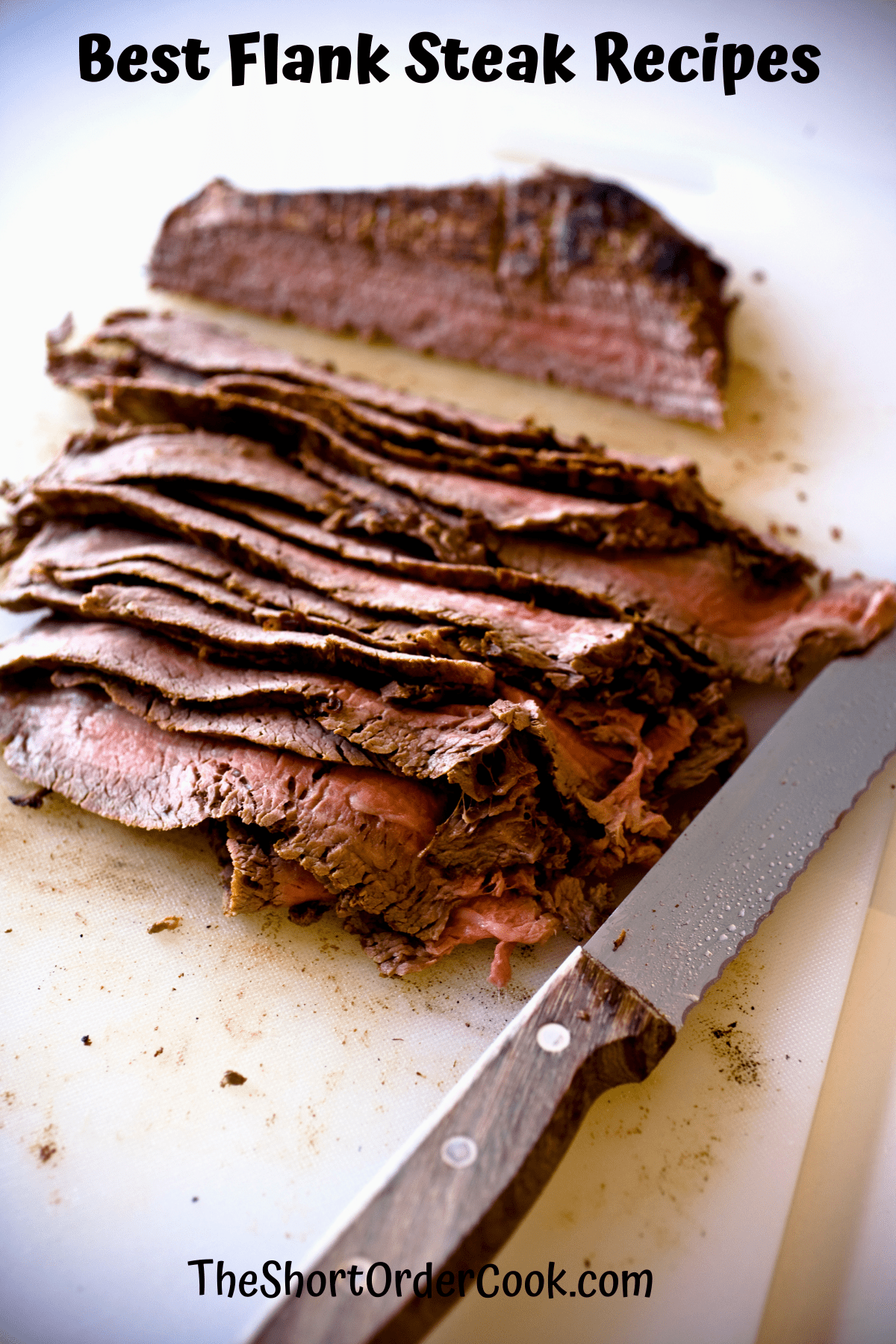 Grilled flank steak marinated and sliced on a cutting board with a knife. 