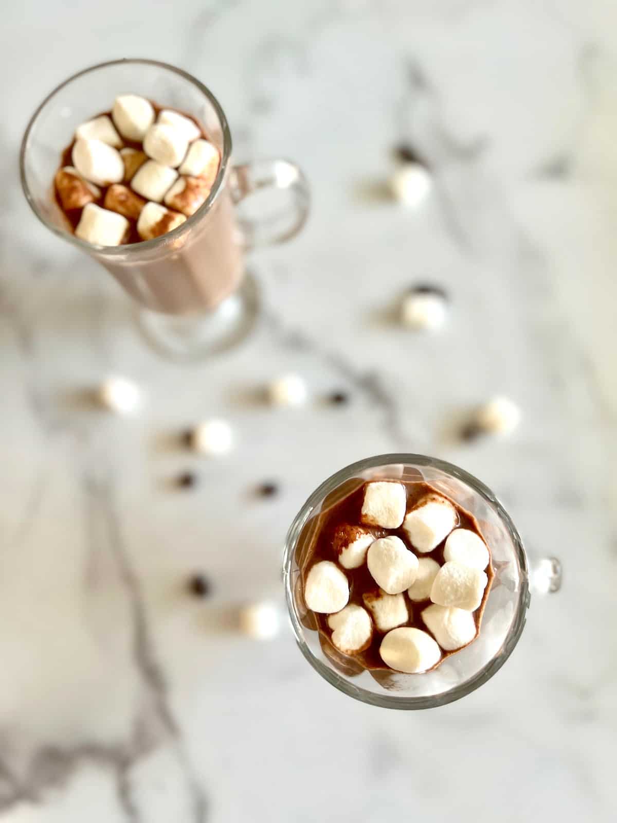 Best Hot Chocolate with Chocolate Chips Overhead of two glasses of hot chocolate topped with marshmallows.