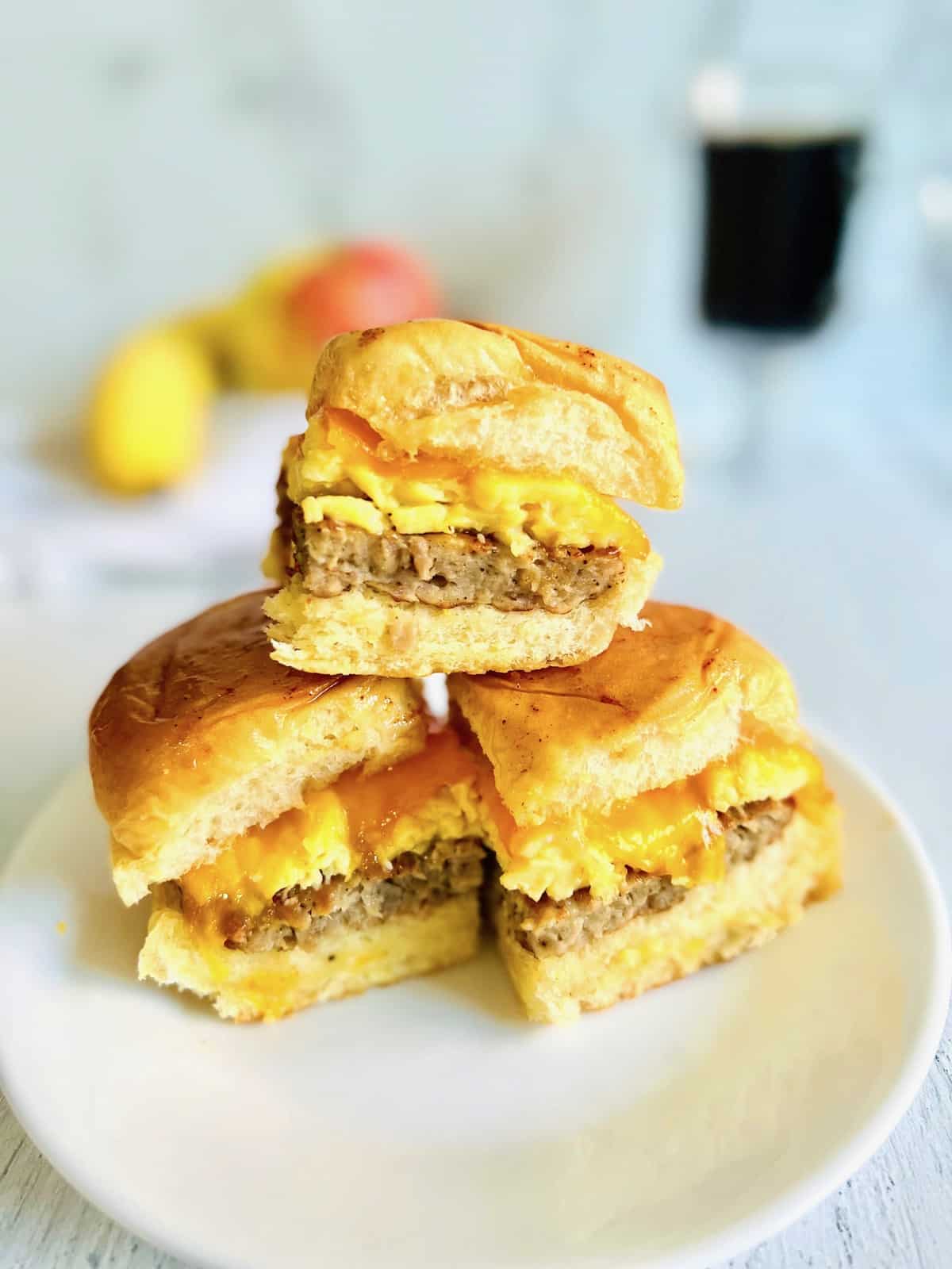 Hawaiian Roll Breakfast Sliders Plated with coffee and fruit in the background.