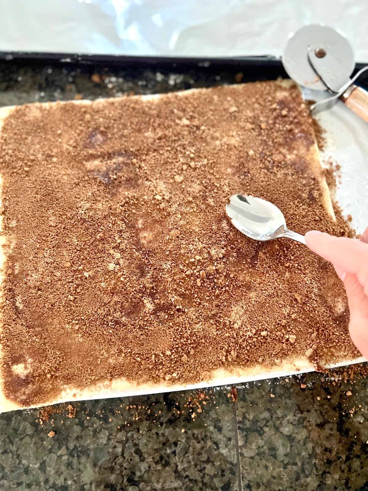 Spreading the cinnamon brown sugar on the puff pastry.