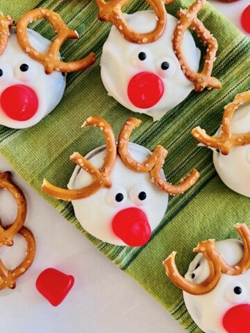 White coated Oreo cookies decorated to look like reindeer.