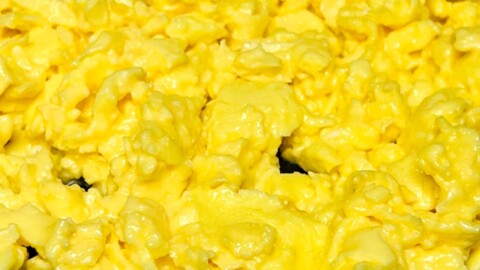 Soft scrambled eggs in a skillet.