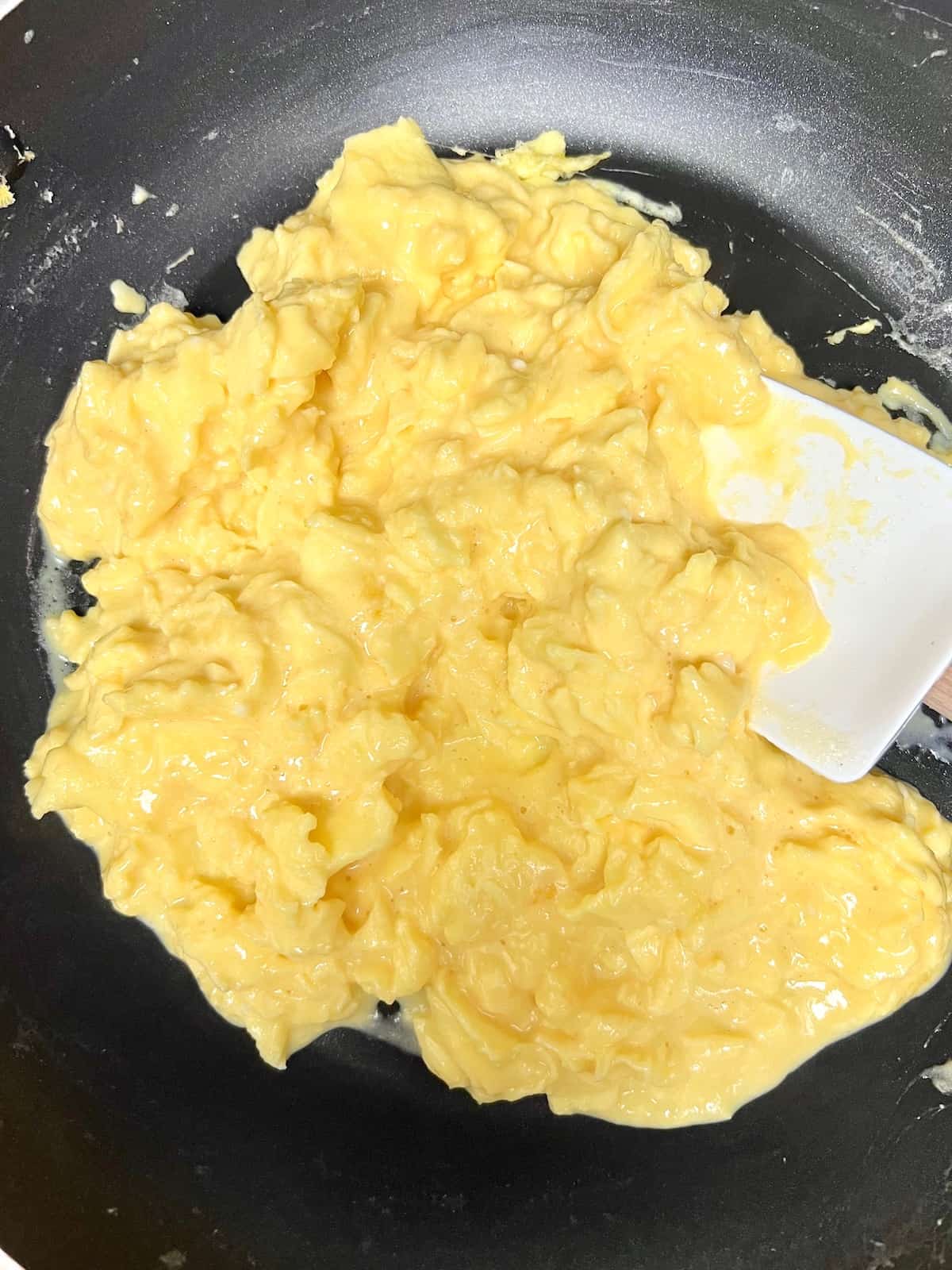 Soft Scrambled Eggs Wet and moist eggs in the skillet almost ready.