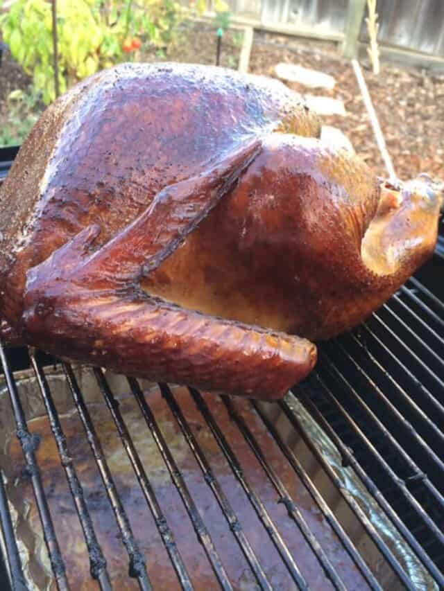 Smoked turkey on a grill.