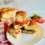 Stacked caprese sliders on a plate.