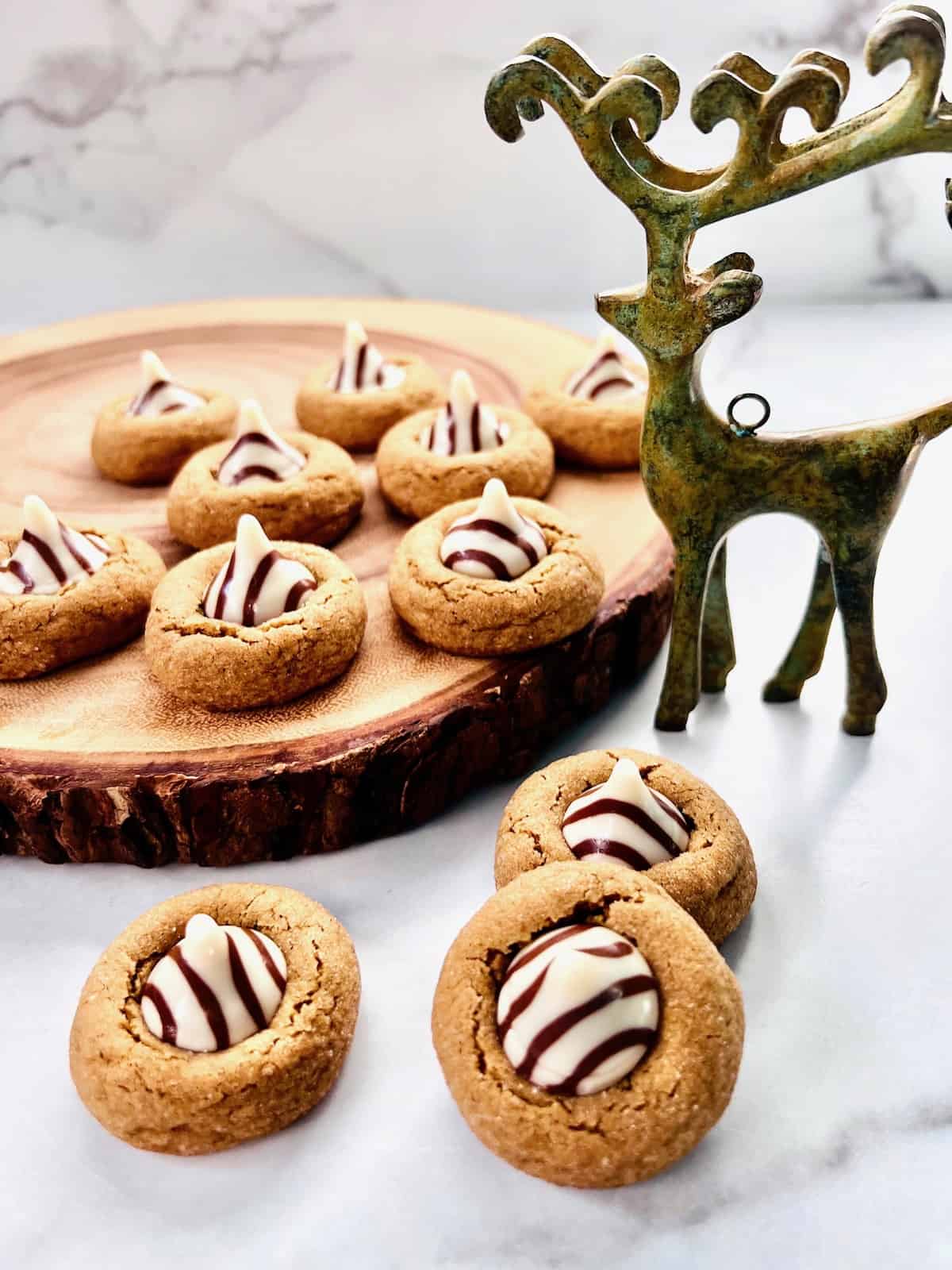 Gingerbread Blossoms with Hershey's Hugs on wood slab and metal reindeer decoration.