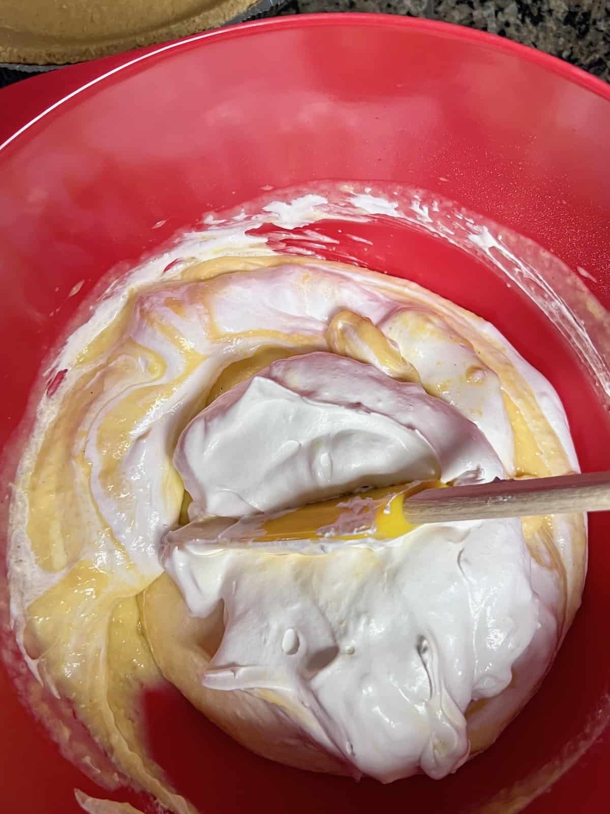 Folding Cool Whip into pudding & eggnog mixture.