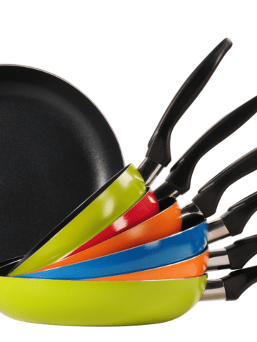 Brightly colored saute and fry pans stacked up.