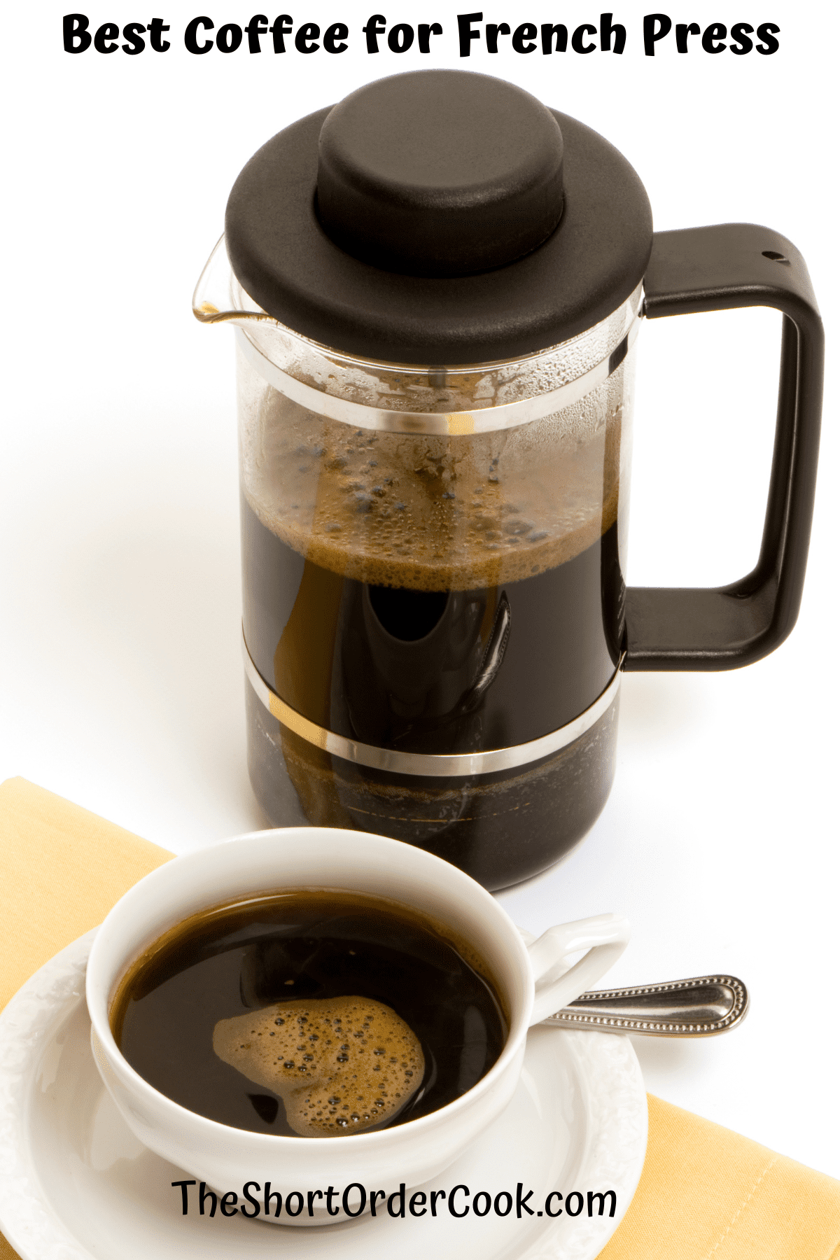 A french press filled with coffee and a full cup of coffee.